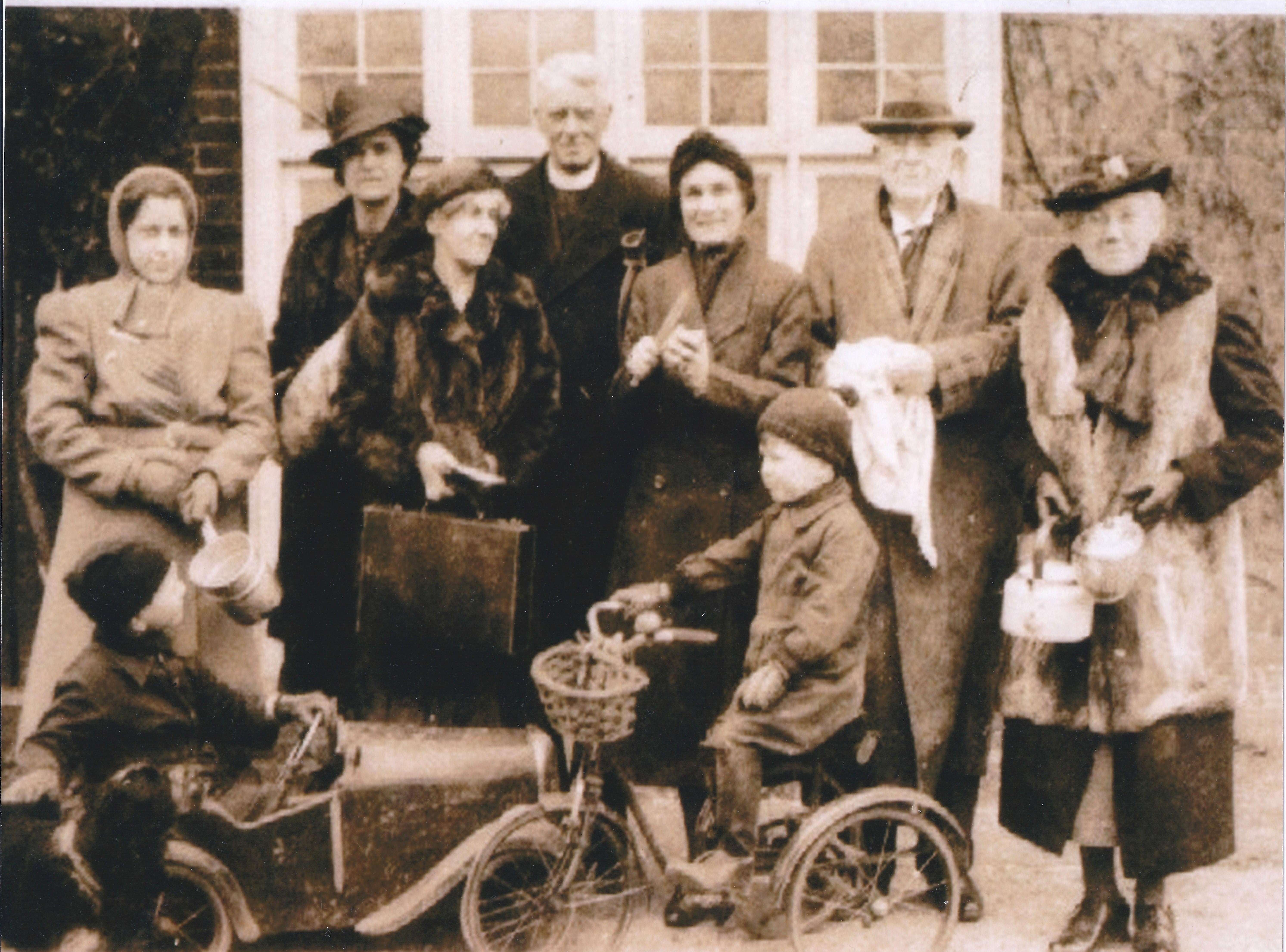 Rev H Bissecker centre & wife Doris to right of him. Grandchildren Michael & Nigel Payne on bikes (during WWII)