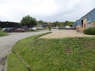 Entrance to Button End Industrial estate looking to west with disused gravel pits behind 2015 | (Roadley)