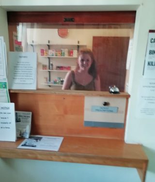 Work behind protective glass at Harston dispensary during Covid 19; May 2020 | (Roadley)